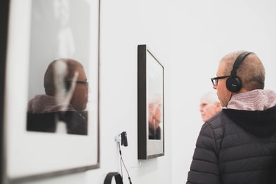 Wearing black headset man standing near the wall coverings
